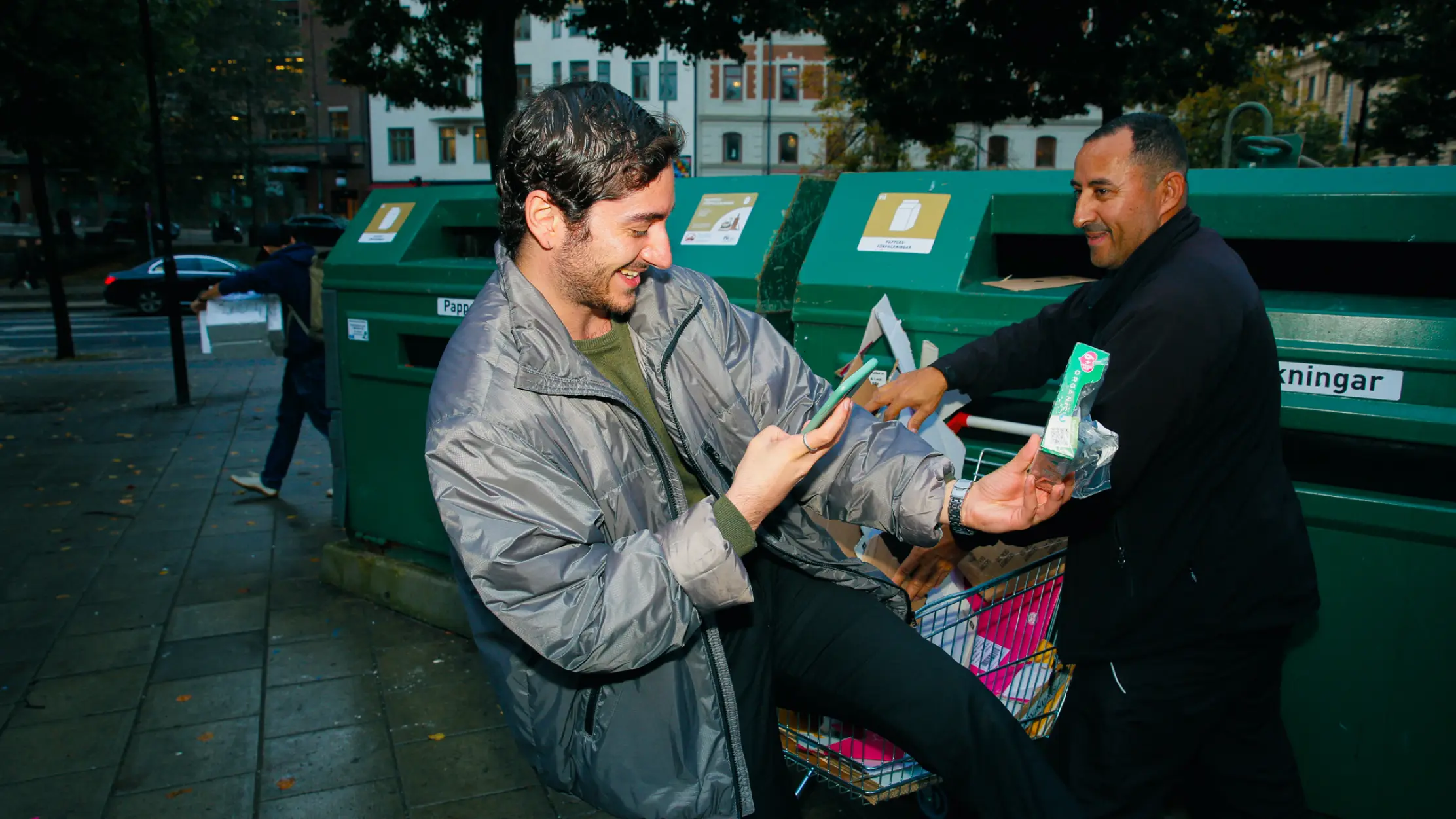 A man scanning a package by a recycling station